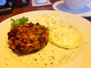 Eggs over-easy with sweet potato and andouille hash